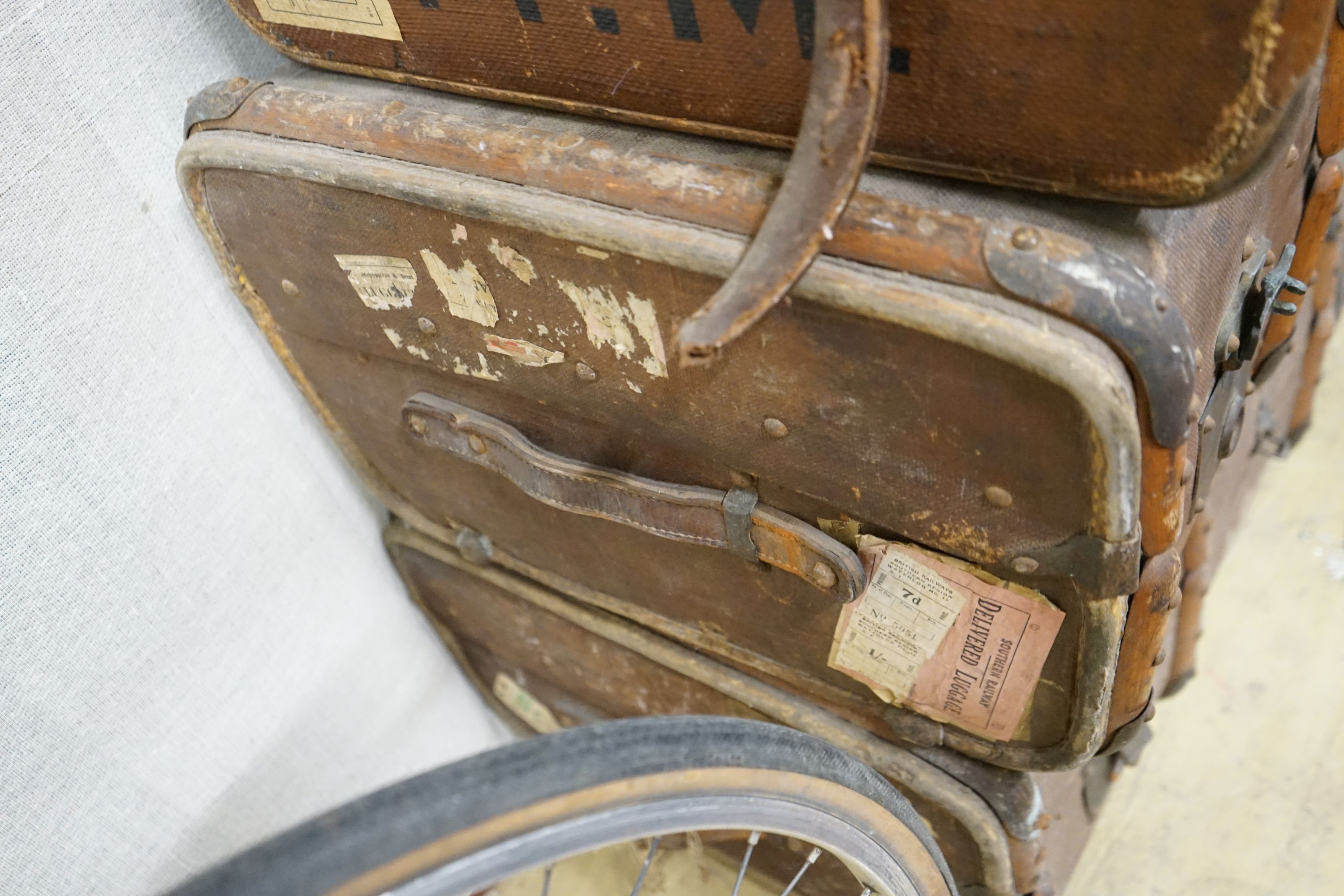 A collection of five vintage suitcases, largest width 83cm